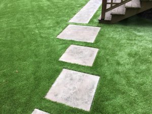 Pavers cut into synthetic grass . Brookline MA