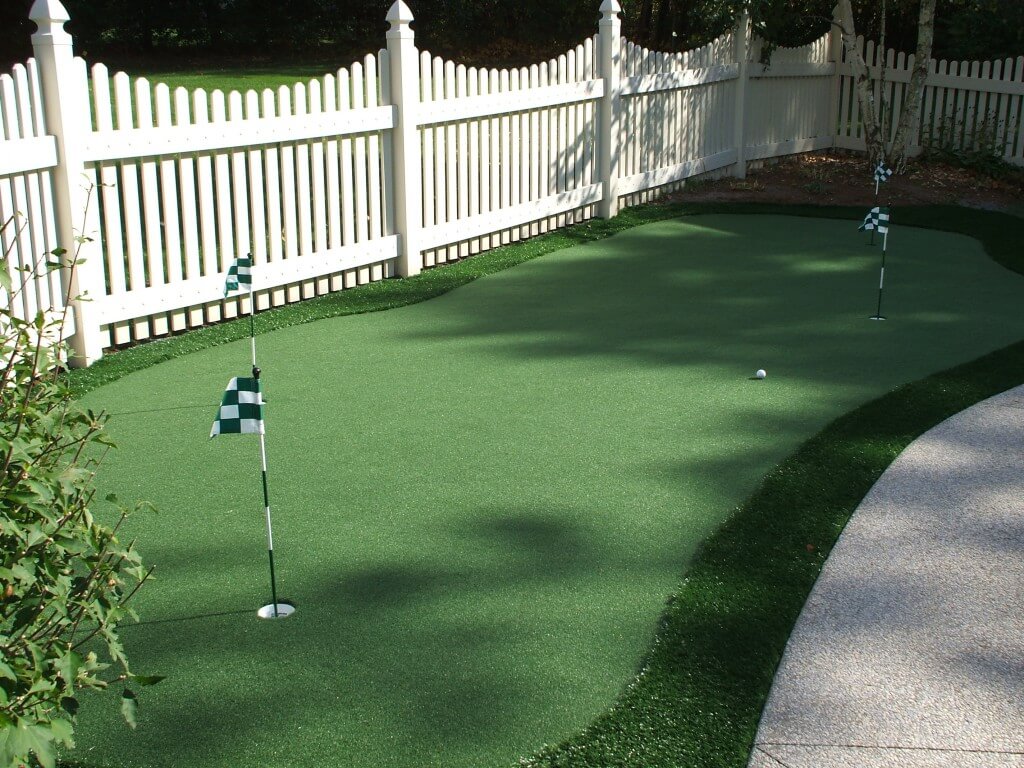 white picket fence and putting green