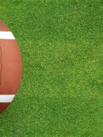 American,Football,Ball,On,Green,Grass,Field,Background.